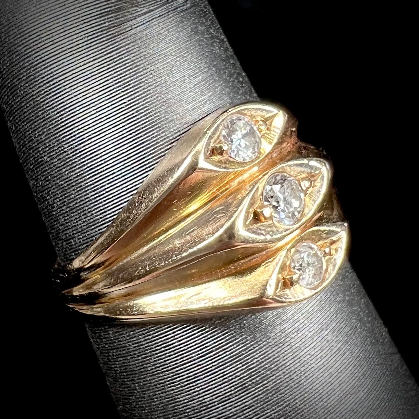 A vintage 1940's style ladies' yellow gold three stone diamond ring.