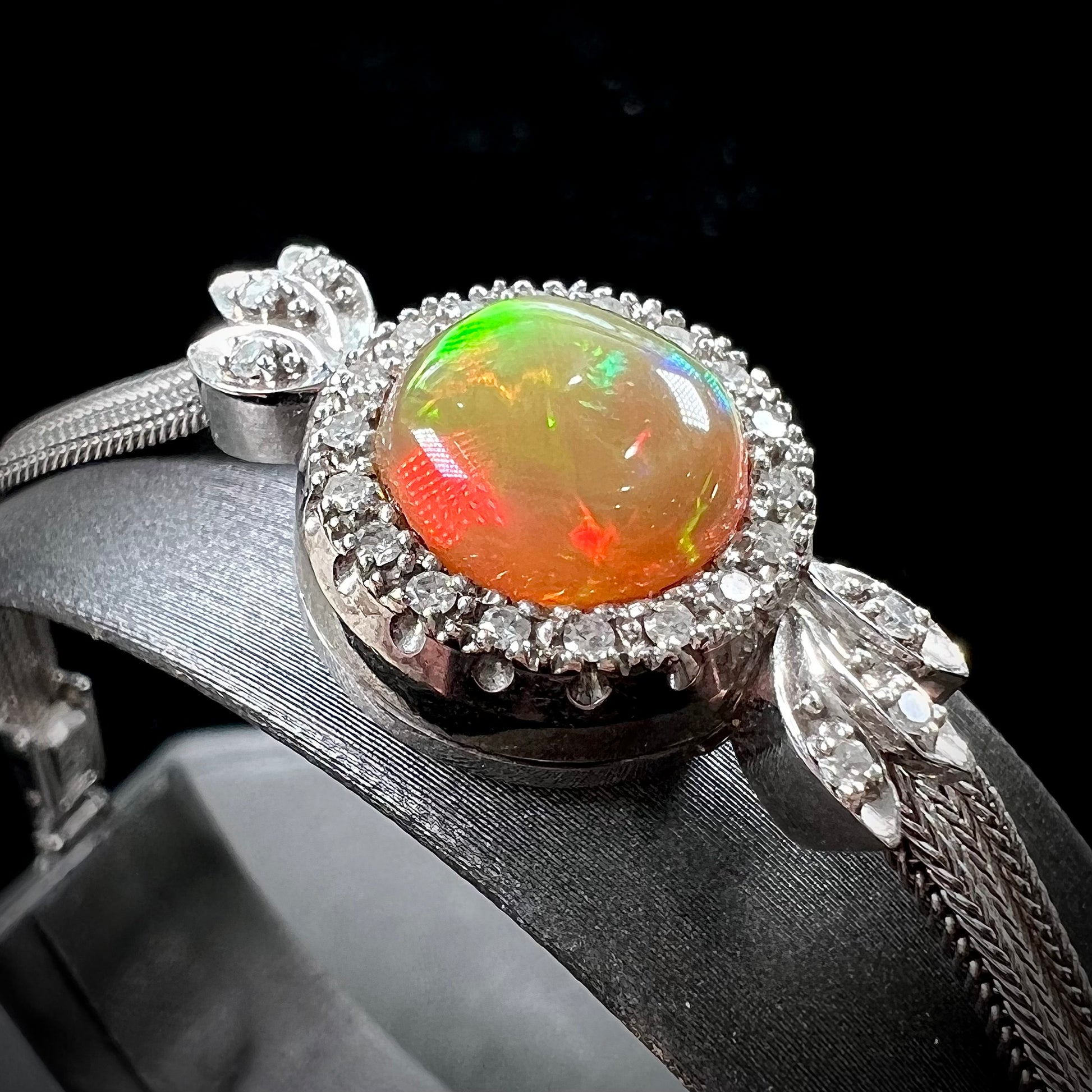 A Virgin Valley fire opal and diamond bracelet made from a vintage 1930's watch.
