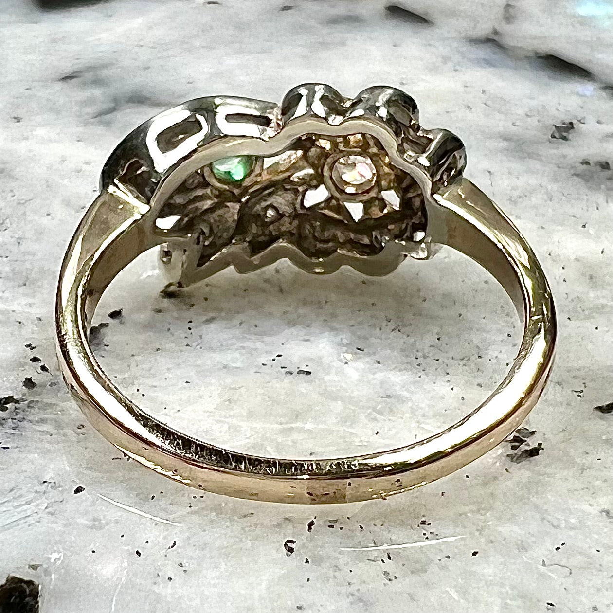 Vintage gold round cut emerald and diamond ring.