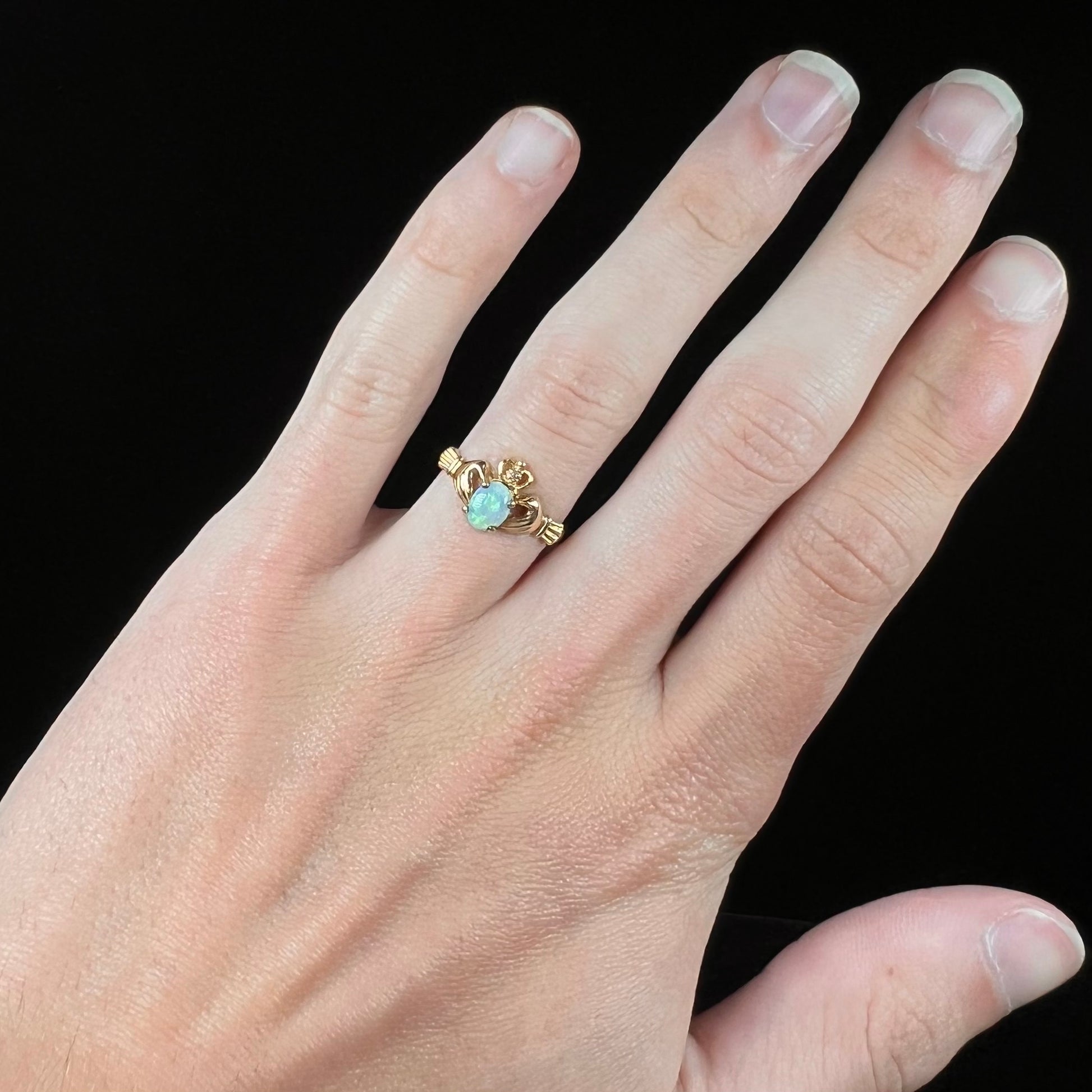 A vintage ladies' yellow gold opal and diamond claddagh ring.