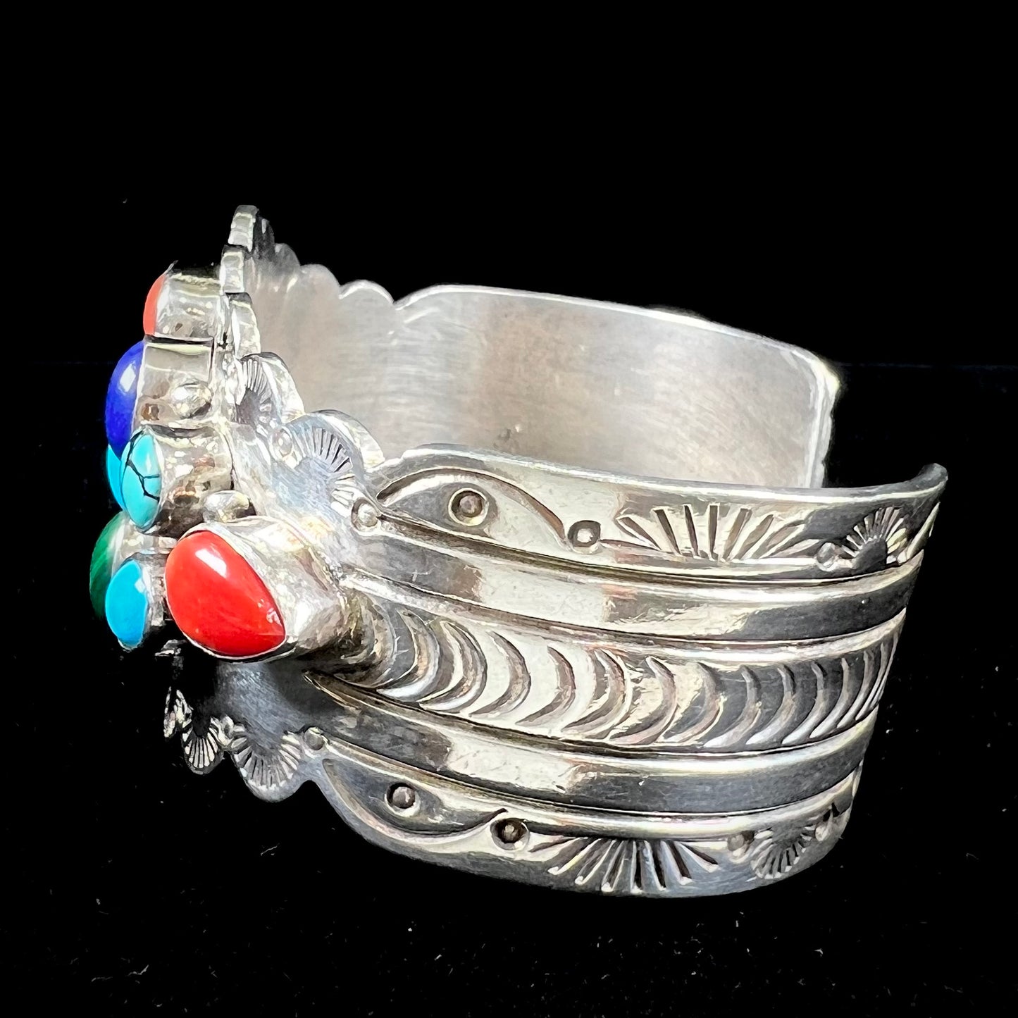 A sterling silver ladies' Navajo cuff bracelet set with turquoise, malachite, lapis lazuli, and coral stones.