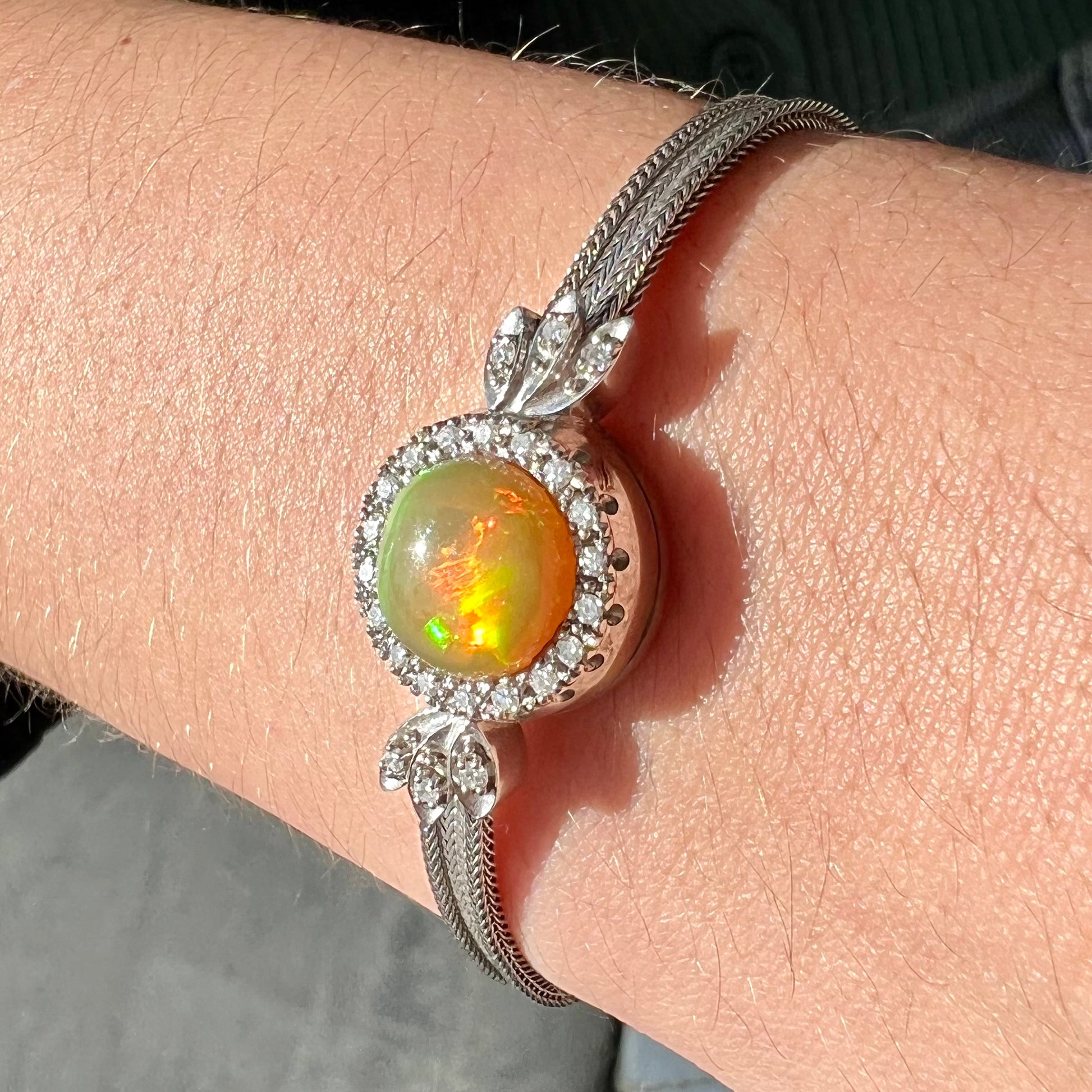 A Virgin Valley fire opal and diamond bracelet made from a vintage 1930's watch.