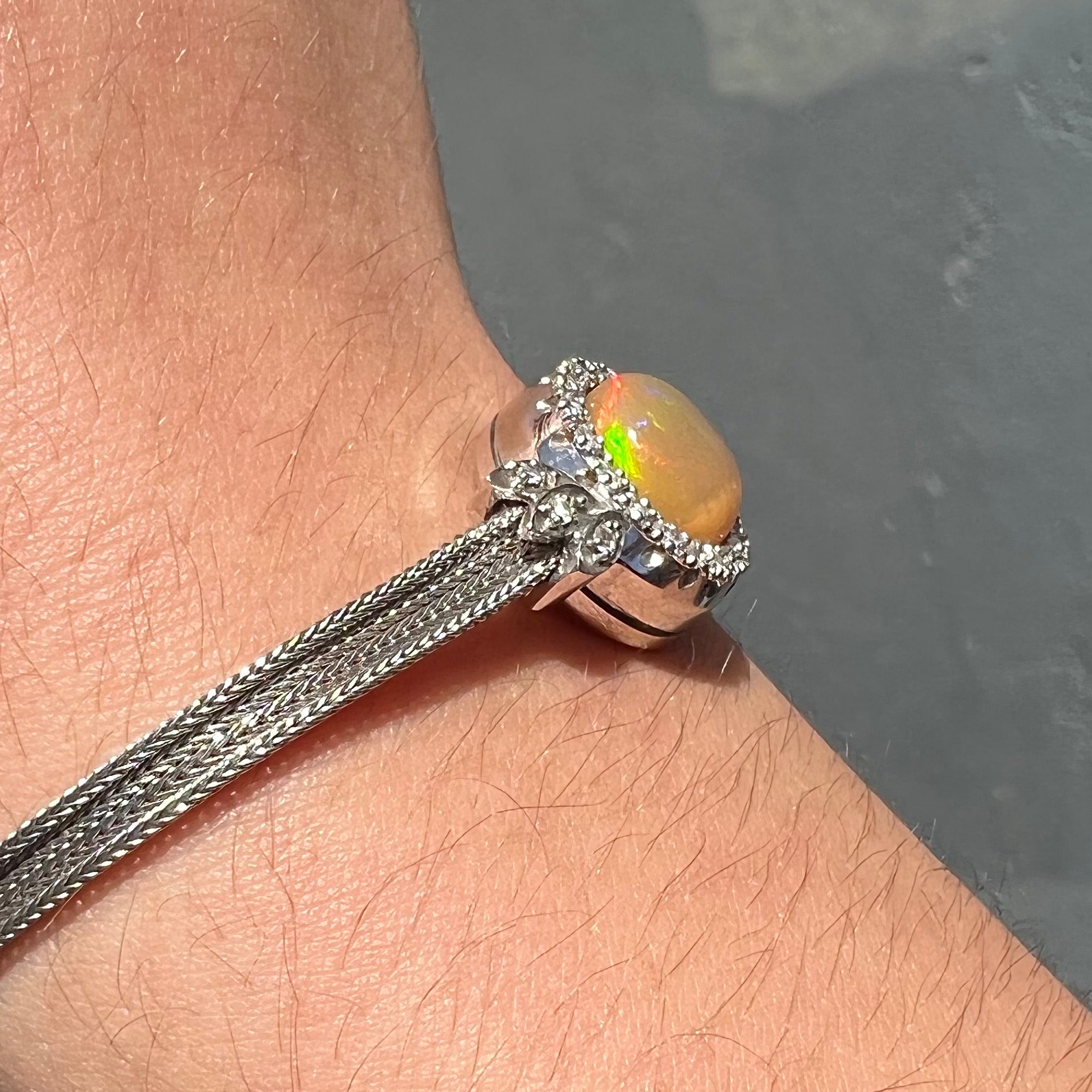 A Virgin Valley fire opal and diamond bracelet made from a vintage 1930's watch.