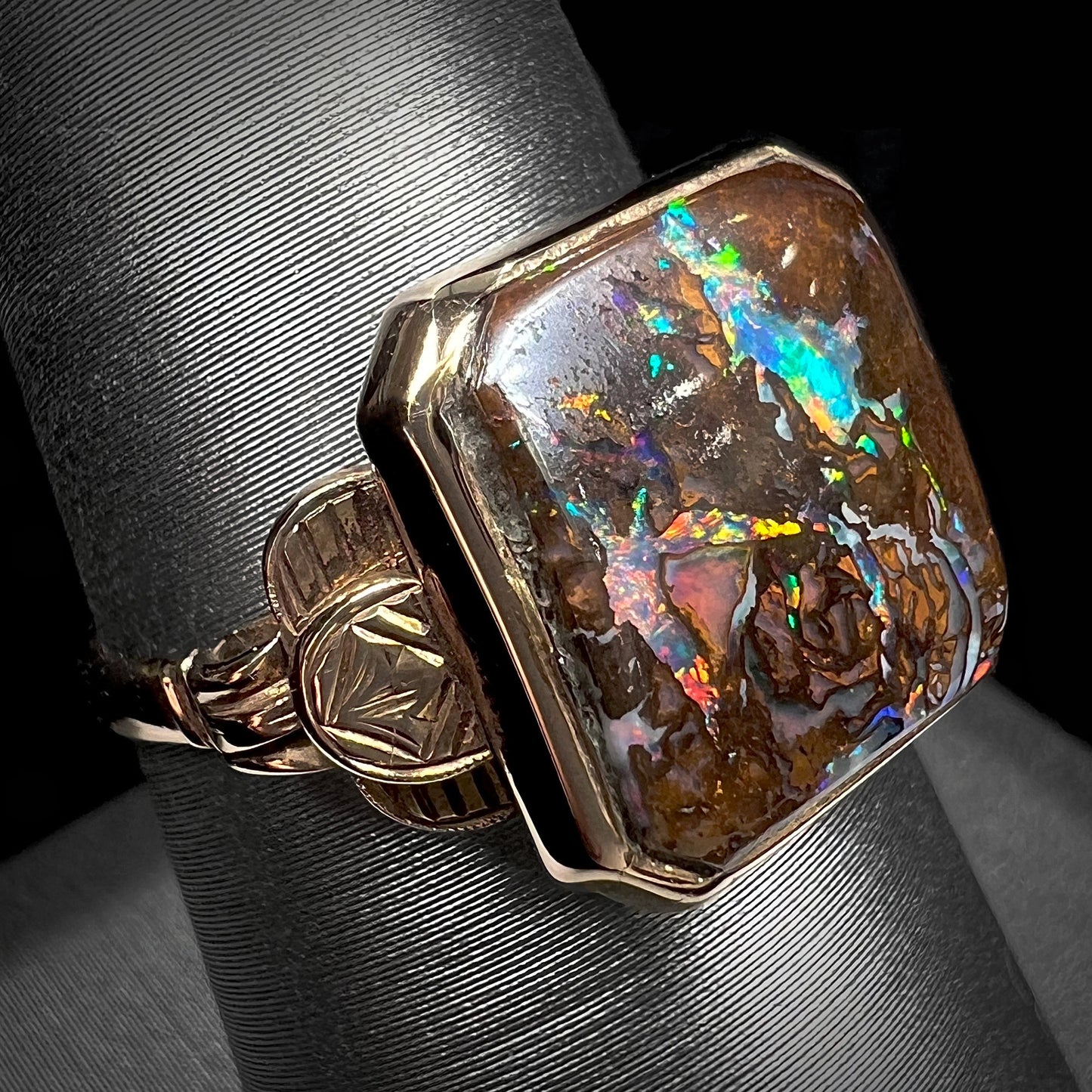 An antique yellow gold boulder opal ring.  The stone is a sqaure cut natural opal from Quilpie, Australia.