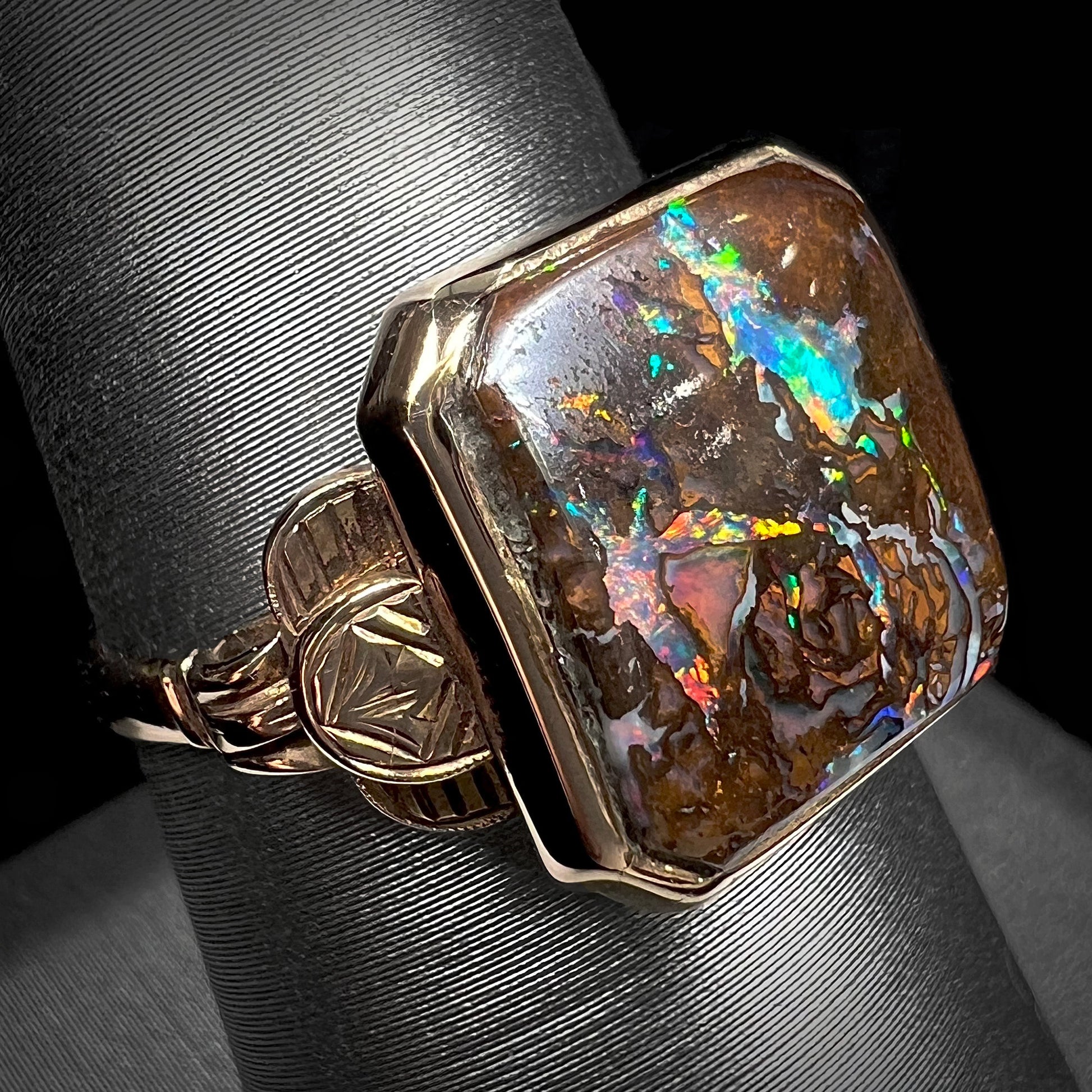 An antique yellow gold boulder opal ring.  The stone is a sqaure cut natural opal from Quilpie, Australia.