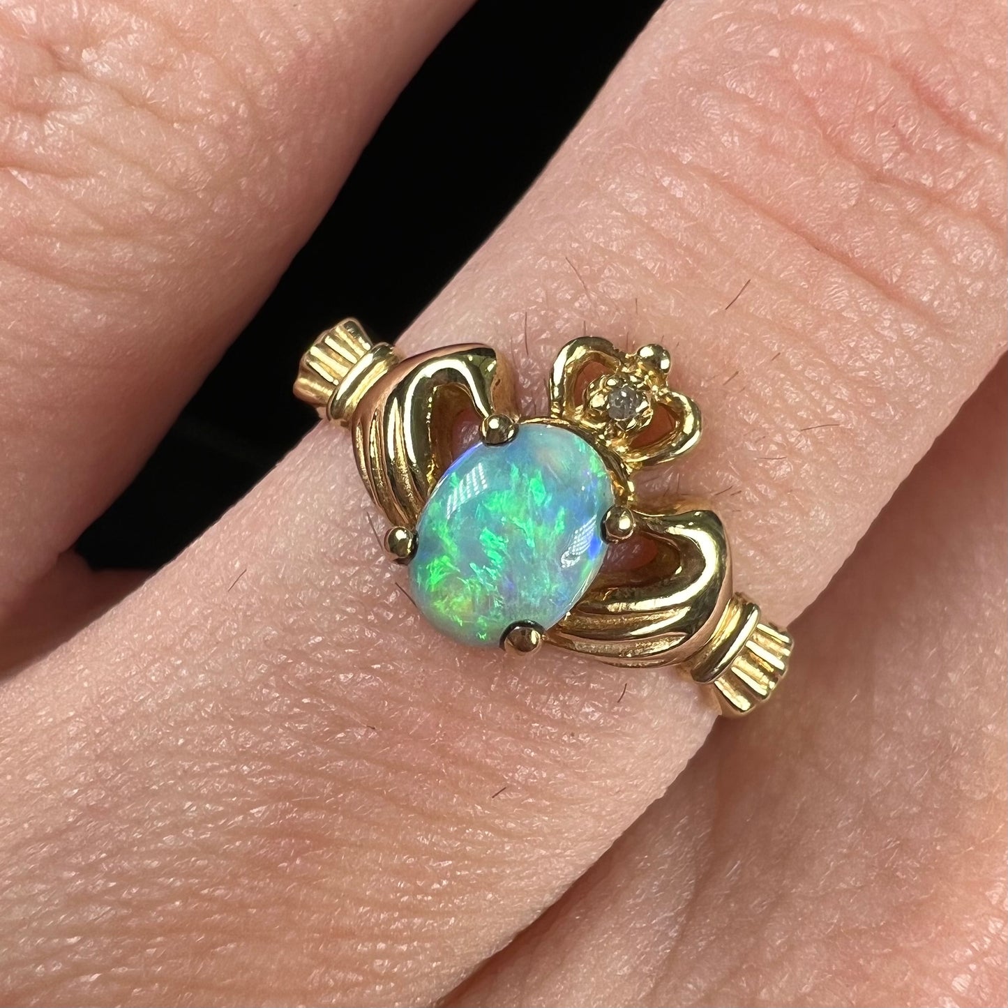 A vintage ladies' yellow gold opal and diamond claddagh ring.