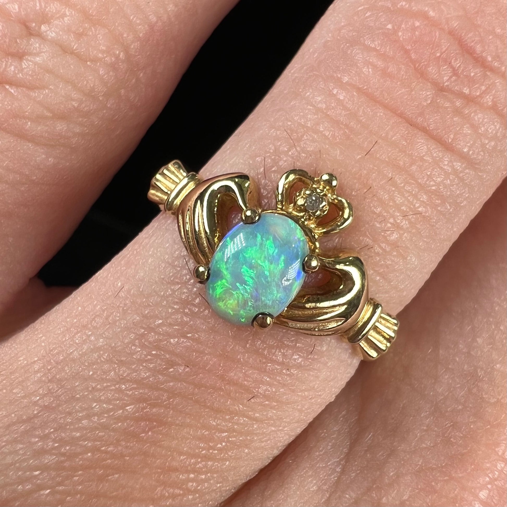 A vintage ladies' yellow gold opal and diamond claddagh ring.