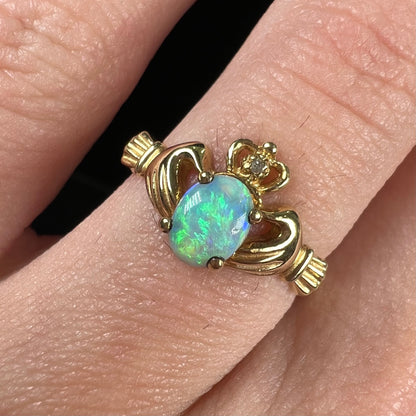 A vintage ladies' yellow gold opal and diamond claddagh ring.