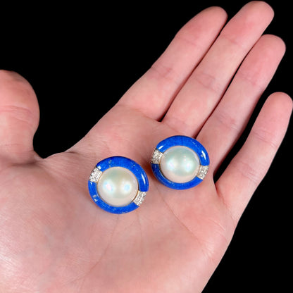 A pair of mabe pearl earrings set into lapis lazuli stone inlay with diamond accents.