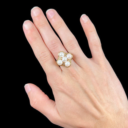 A ladies' vintage 1960's pink Akoya pearl and diamond quatrefoil ring.  The shank of the ring is textured.