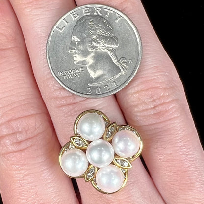 A ladies' vintage 1960's pink Akoya pearl and diamond quatrefoil ring.  The shank of the ring is textured.