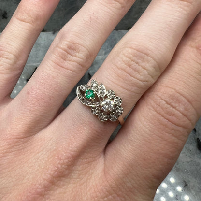 Vintage gold round cut emerald and diamond ring.