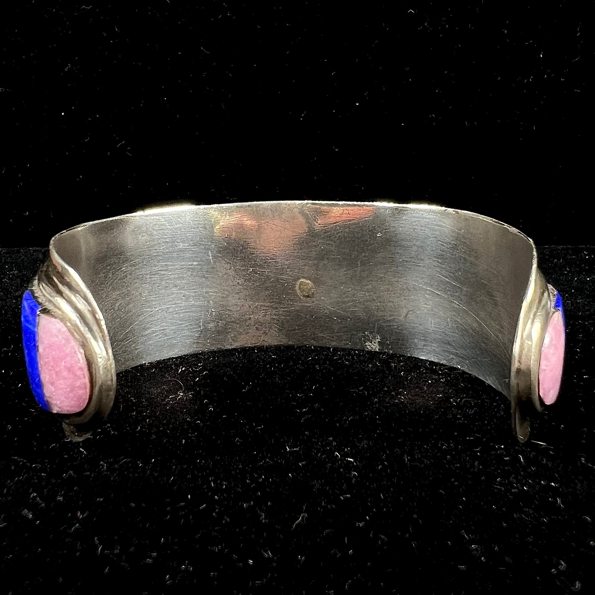 A men's vintage sterling silver Hopi Indian cuff bracelet set with tiger's eye, lapis lazuli, turquoise, jet, and rhodonite.