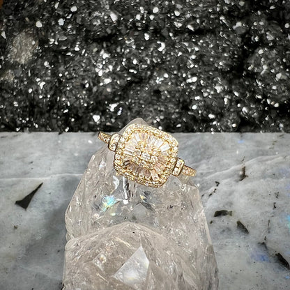 A 1930's style yellow gold diamond cluster ring set with round and baguette cut diamonds.