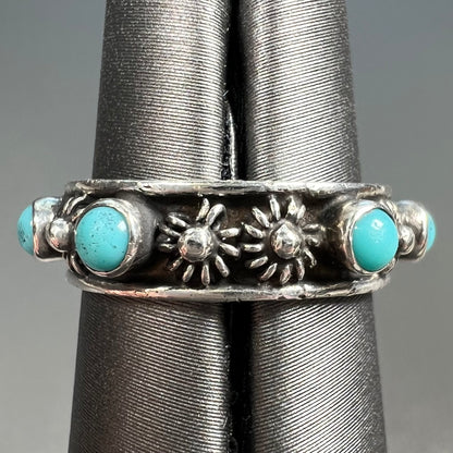 A sterling silver turquoise and flower design eternity band, made in Mexico.