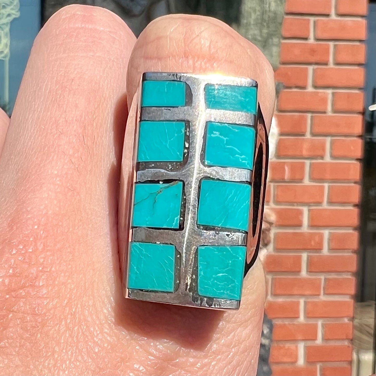 A men's sterling silver turquoise inlay ring, circa 1970.  The piece is set with 8 stones.