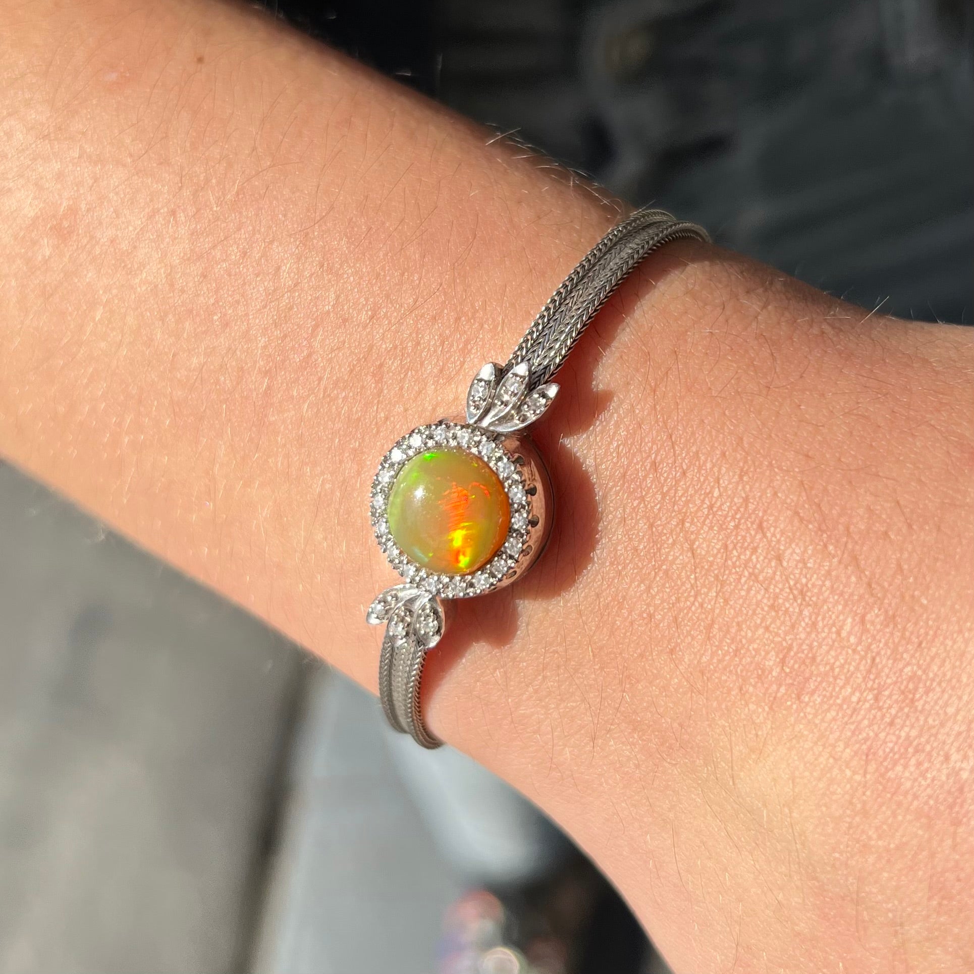 A Virgin Valley fire opal and diamond bracelet made from a vintage 1930's watch.