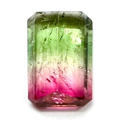 A loose pink and green emerald cut watermelon tourmaline gemstone.