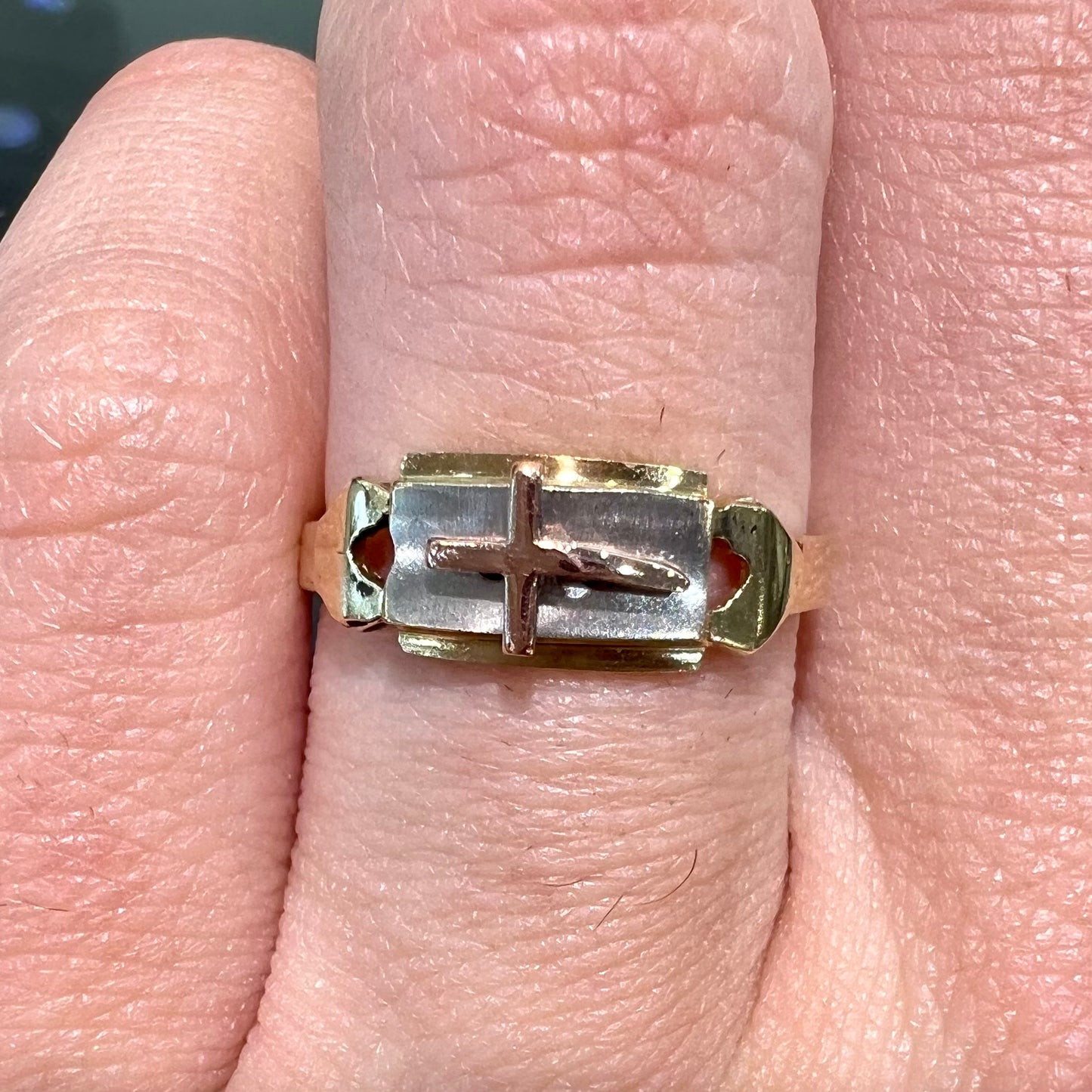 A tricolor gold cross ring handmade from rose, white, and yellow gold.