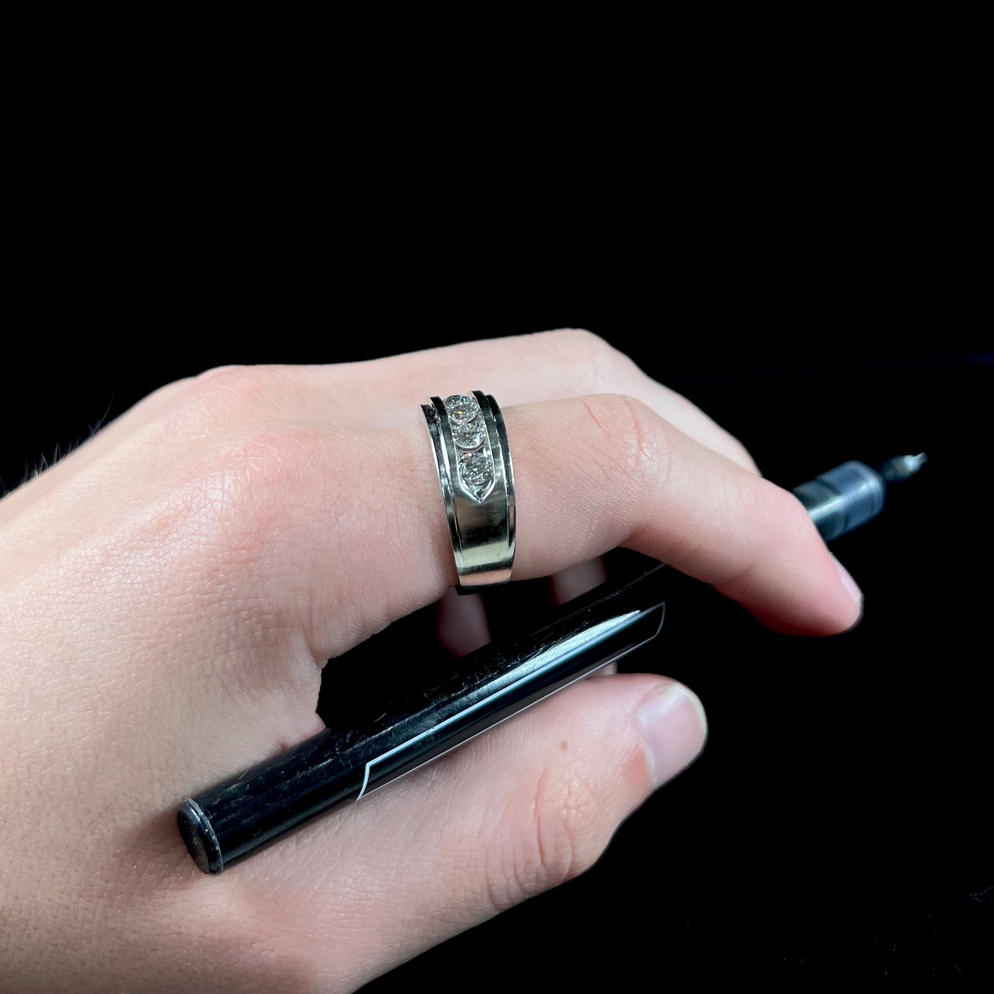 A men's estate white gold five stone diamond ring.