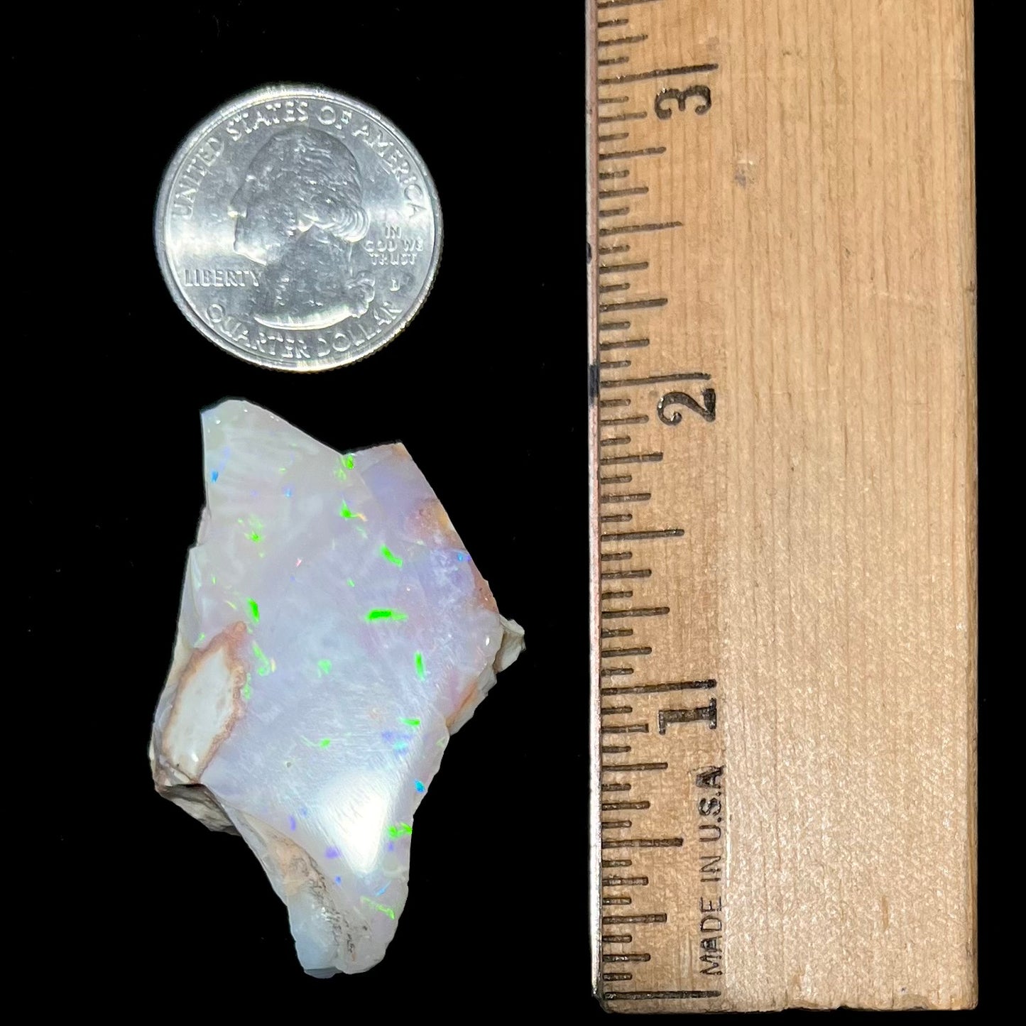 A loose, polished specimen of white crystal opal from Spencer, Idaho, USA.