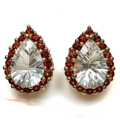 Pear shape white topaz and garnet halo stud earrings in yellow gold.