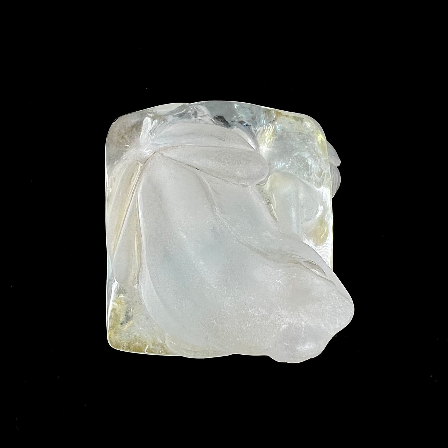 A frog carved from natural white topaz crystal.