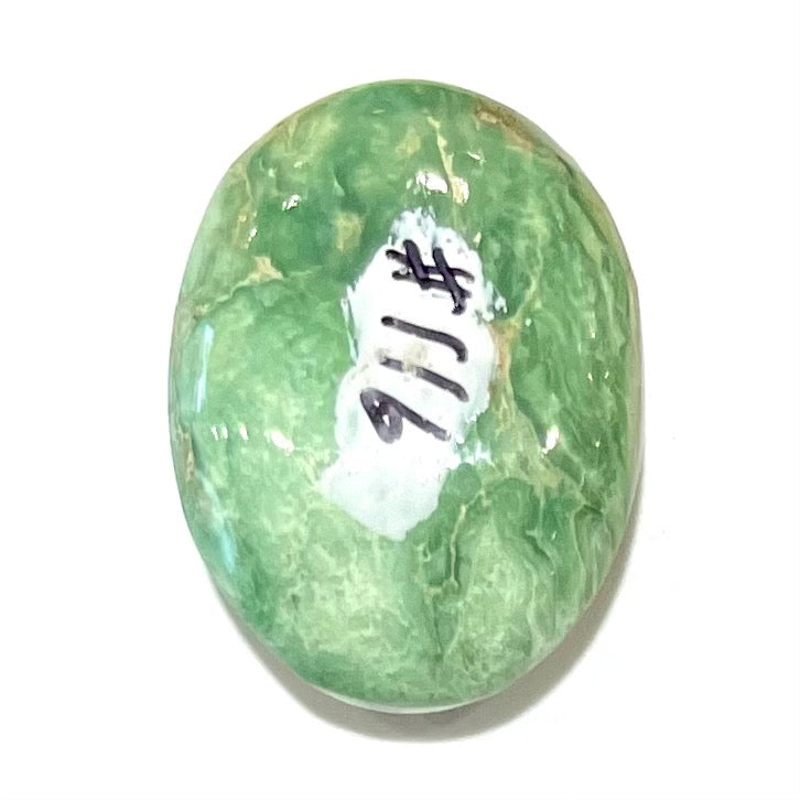 A loose, green oval cabochon cut turquoise stone from the Royston Mining District in Nevada.  Green color marbles around a light brown eye.