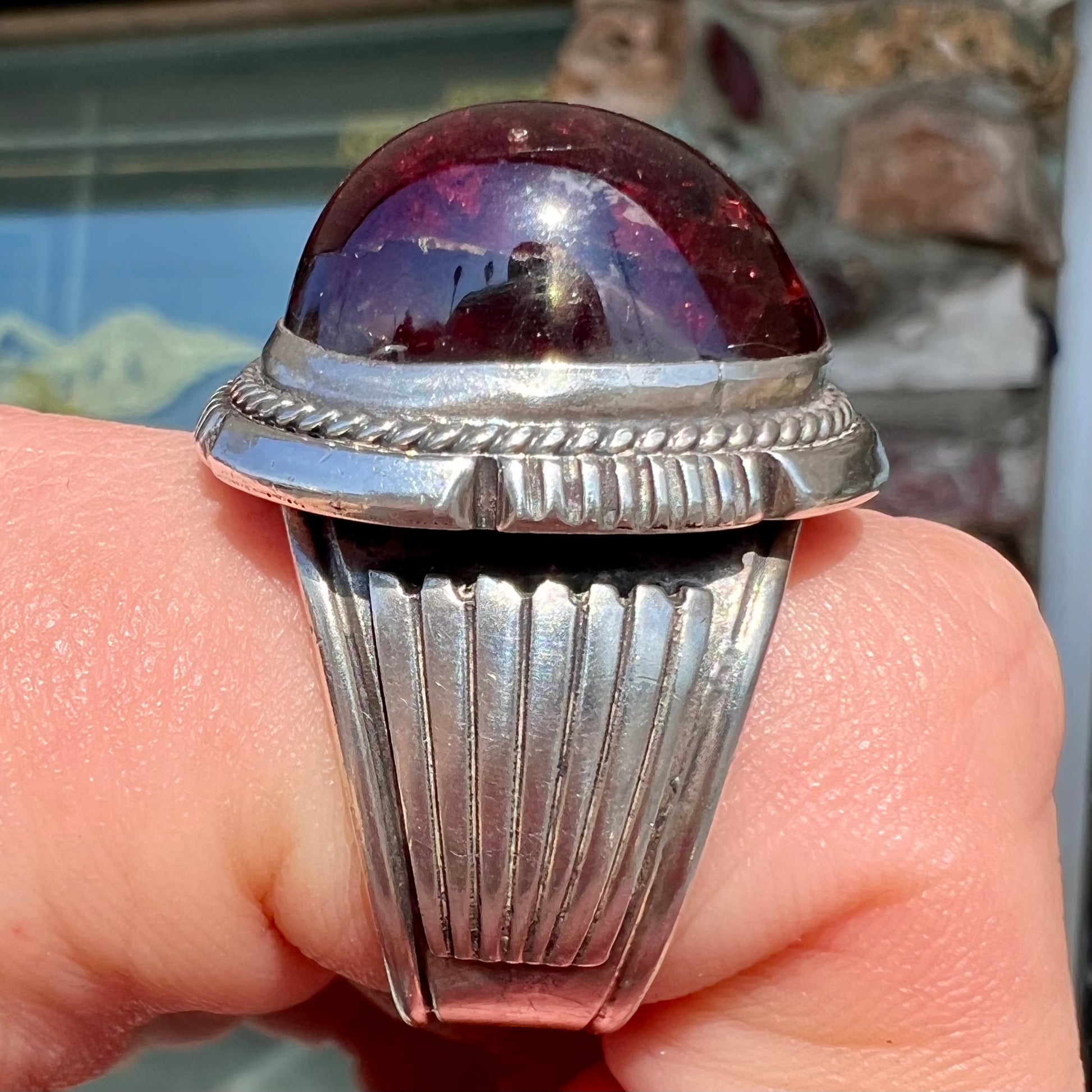 A men's sterling silver garnet ring handmade by Navajo artist Will Denetdale.