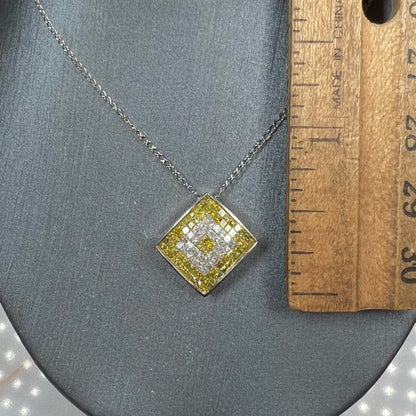 A square shaped necklace set with princess cut yellow and white diamonds in a white gold setting on a white gold chain.