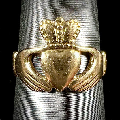 A ladies' 14 karat yellow gold Irish claddagh ring stamped with the maker's hallmarks.