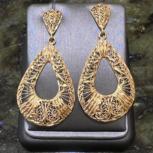 A pair of 14kt yellow gold filigree dangle earrings.  The earrings have a pear shape open design.