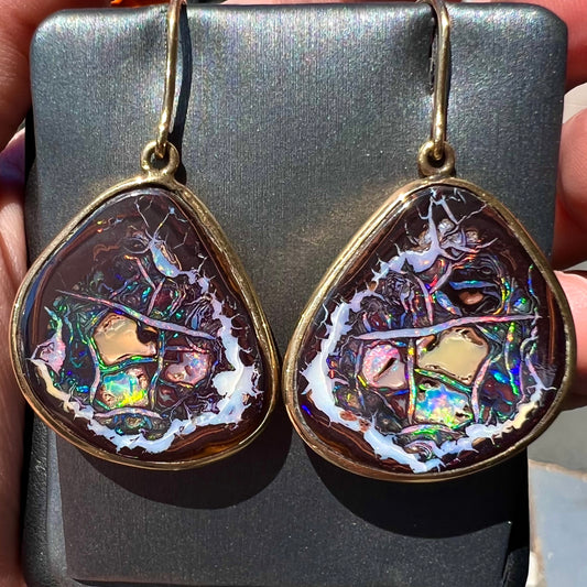 A pair of yellow gold bezel set Yowah nut boulder opal dangle earrings.