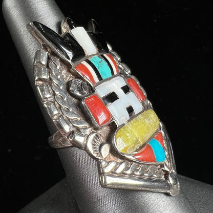 A sterling silver ring handmade in the motif of a Zuni Indian horned kachina set with onyx, turquoise, coral, mother of pearl, and sulfur quartz stones.