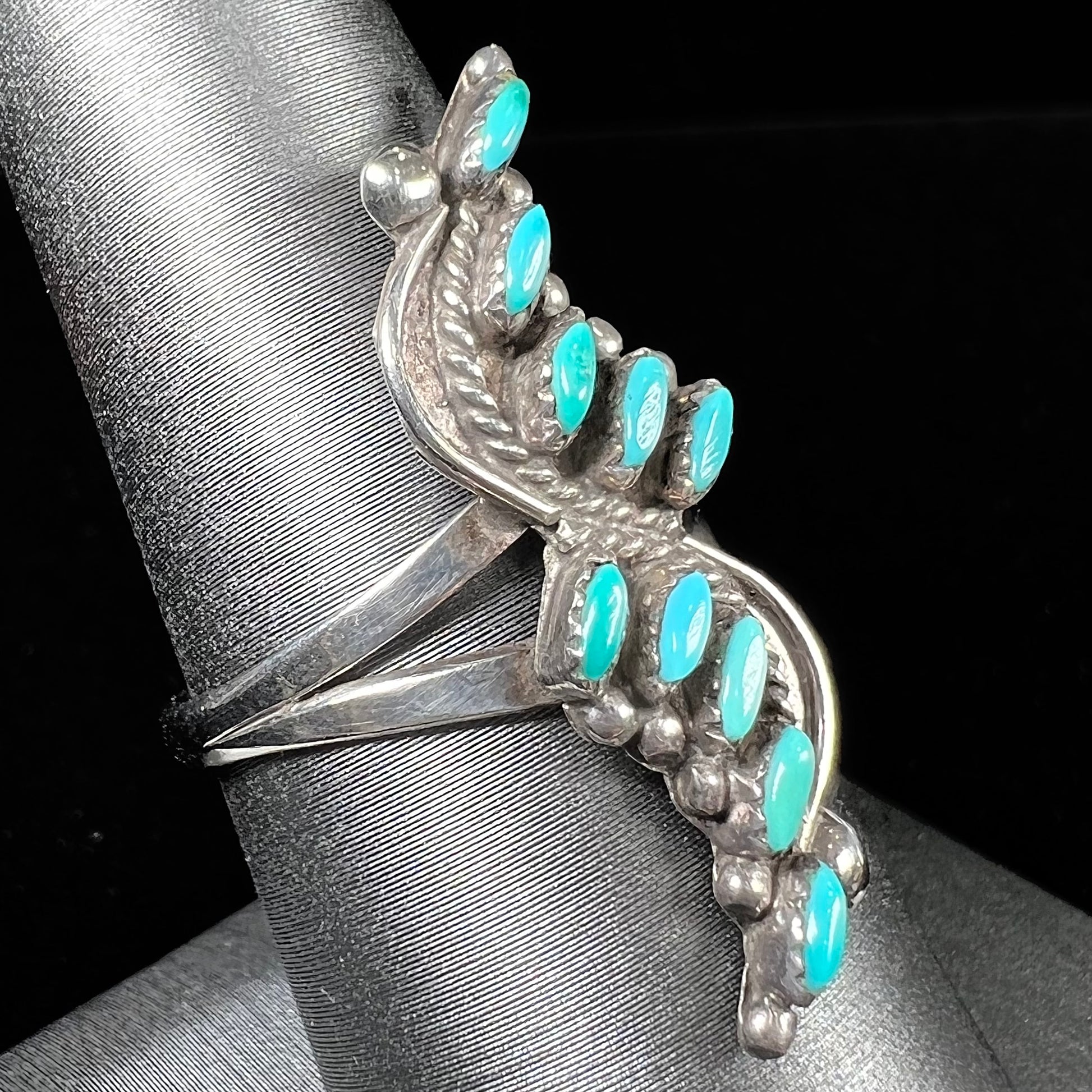 A Zuni needlepoint turquoise ring set in sterling silver.