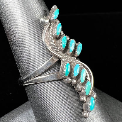 A Zuni needlepoint turquoise ring set in sterling silver.