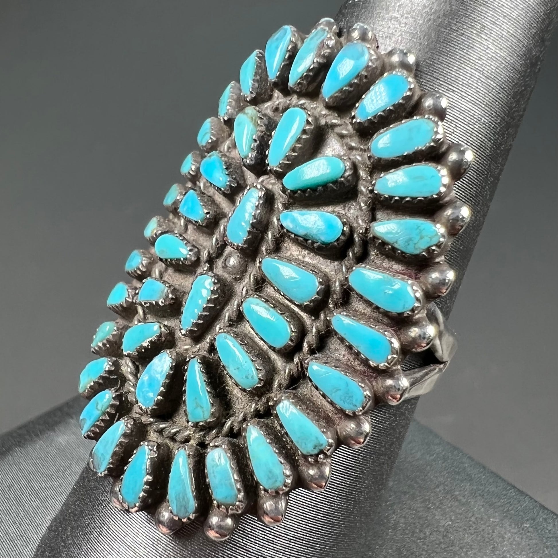 A petit point silver Zuni turquoise ring handmade by New Mexico artist Milburn Dishta.