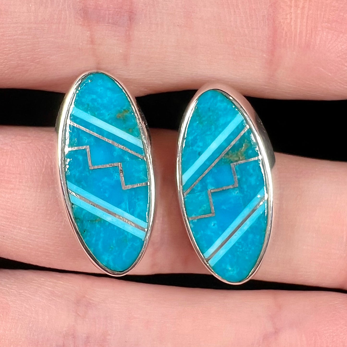 A pair of sterling silver turquoise inlay earrings, handmade by the Zuni artist.