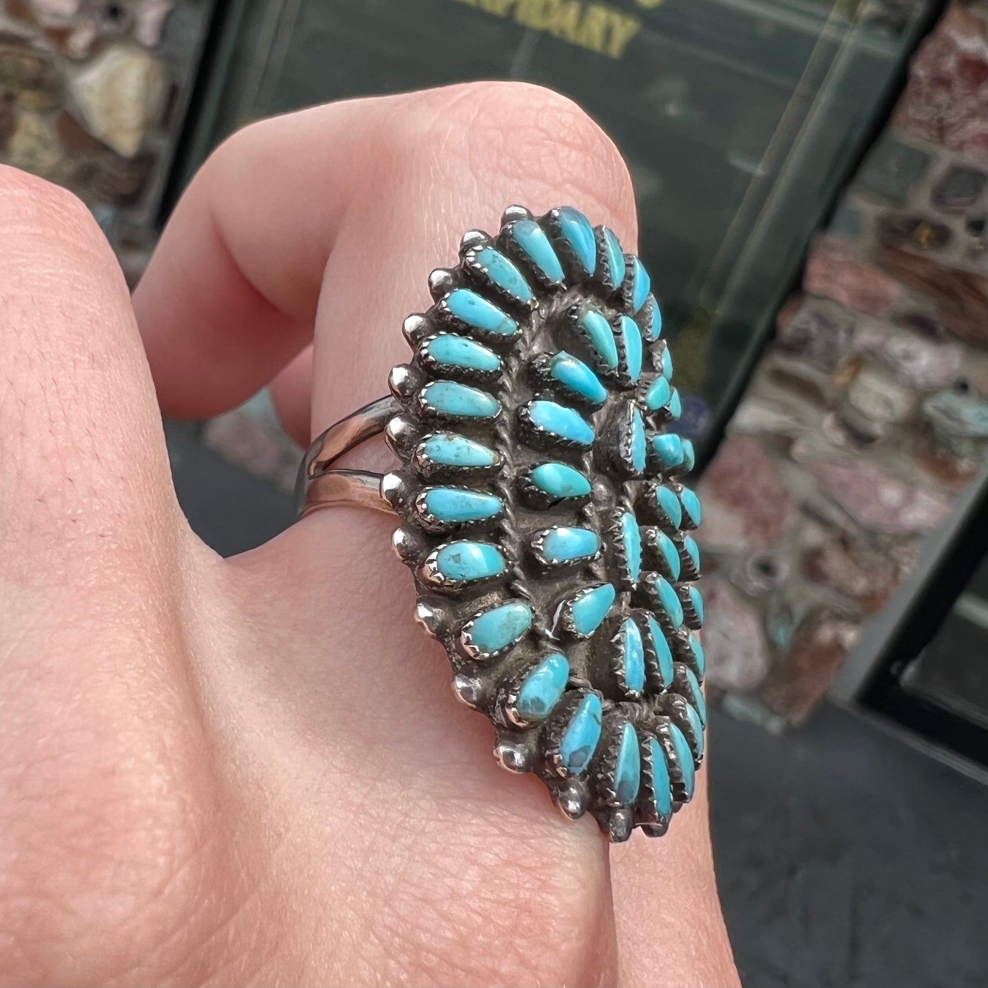 A petit point silver Zuni turquoise ring handmade by New Mexico artist Milburn Dishta.