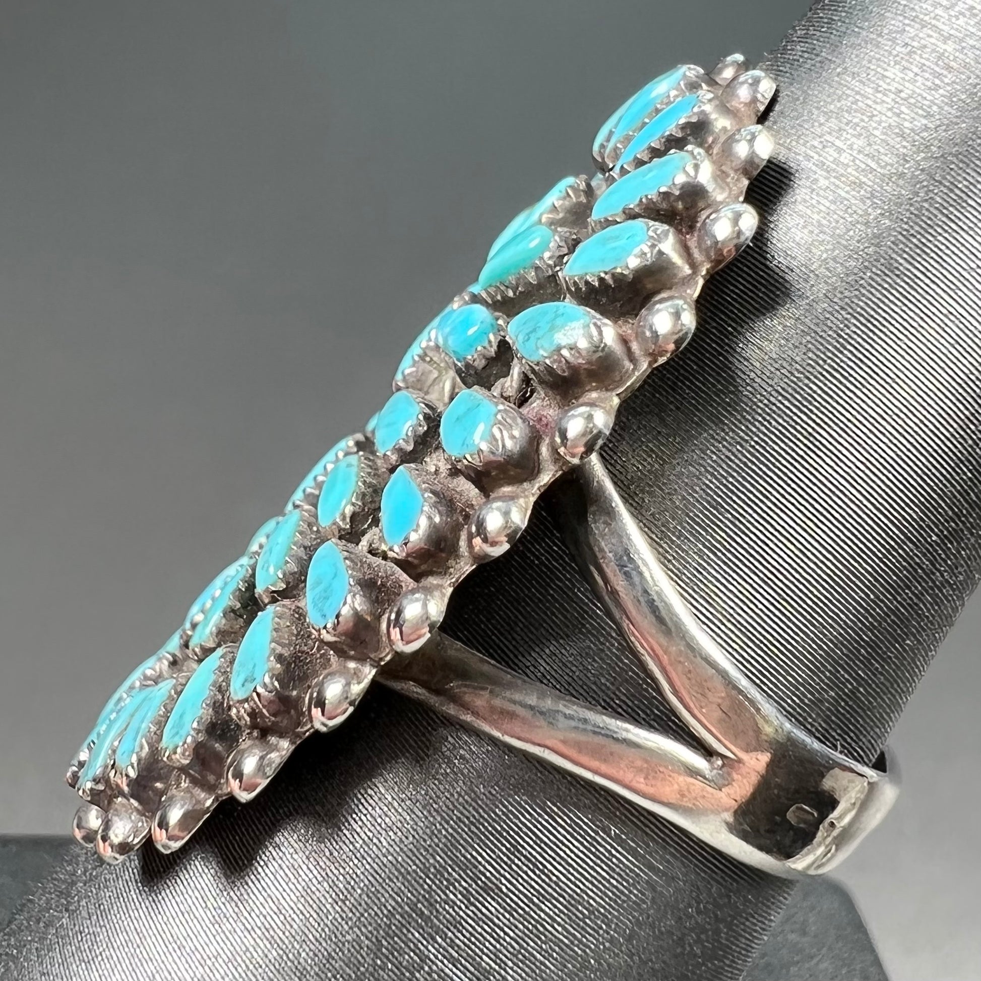 A petit point silver Zuni turquoise ring handmade by New Mexico artist Milburn Dishta.