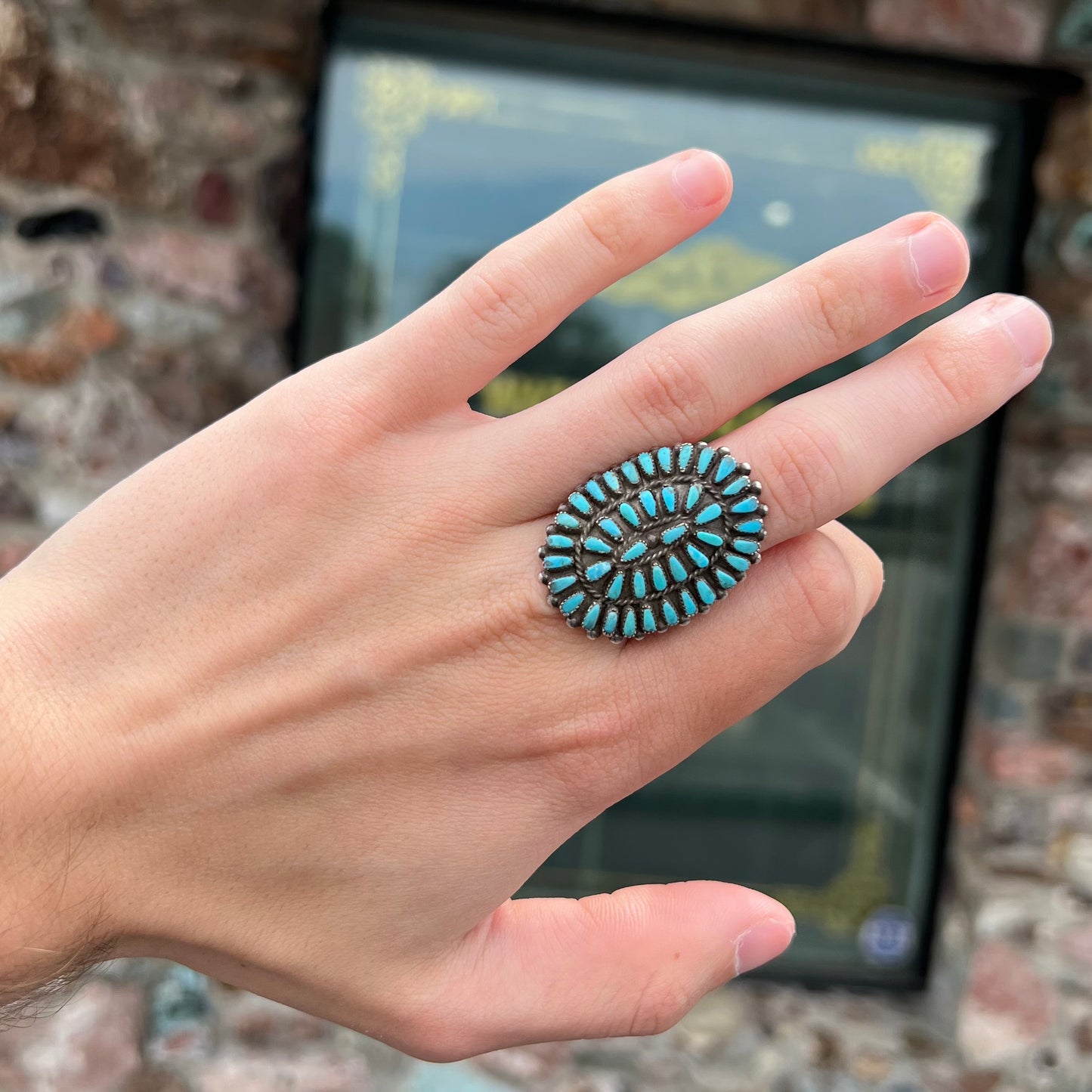 A petit point silver Zuni turquoise ring handmade by New Mexico artist Milburn Dishta.